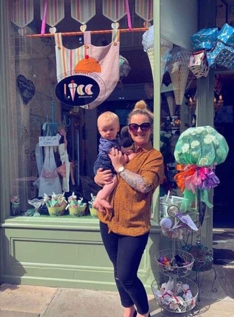 Image may contain: Shop, Urban, Town, Building, City, Sweater, Pants, Face, Accessory, Sunglasses, Accessories, Child, Girl, Teen, Kid, Blonde, Woman, Female, Person, Human, Apparel, Clothing