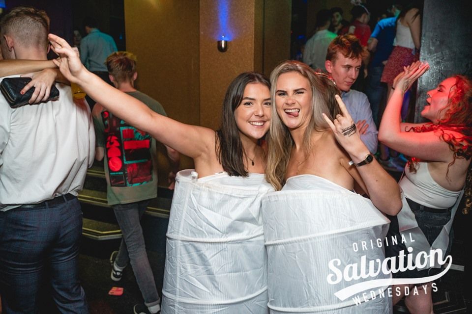 Image may contain: Bar Counter, Pub, Night Life, Evening Dress, Fashion, Gown, Robe, Night Club, Club, Clothing, Apparel, Party, Person, Human