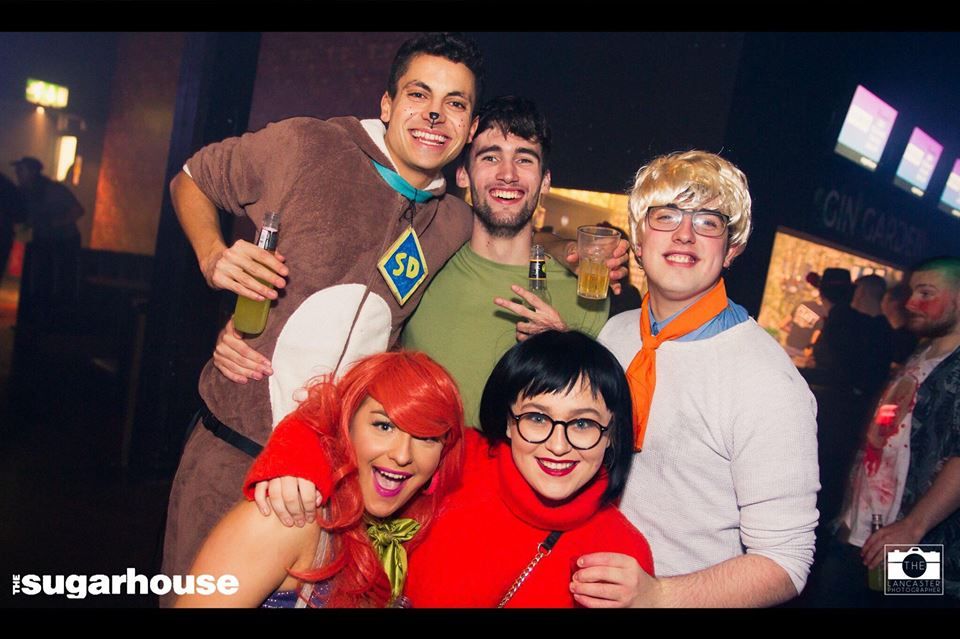 Image may contain: People, Night Life, Photo, Portrait, Photography, Female, Costume, Head, Smile, Apparel, Clothing, Accessories, Glasses, Accessory, Party, Face, Human, Person
