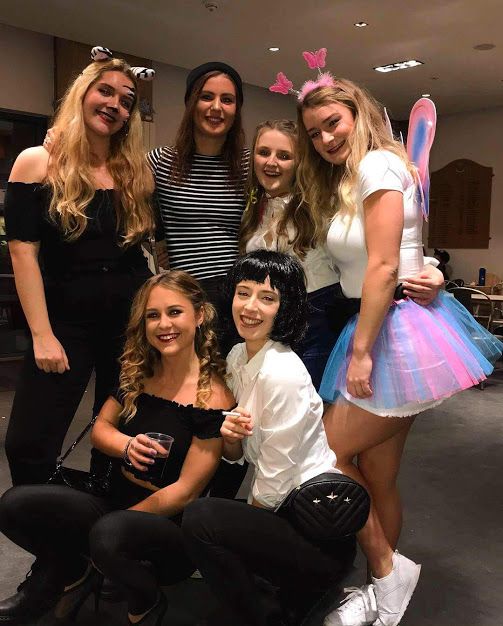 Image may contain: Party, Costume, Jeans, Denim, People, Girl, Furniture, Chair, Smile, Pants, Woman, Face, Skirt, Dress, Human, Female, Person, Apparel, Clothing