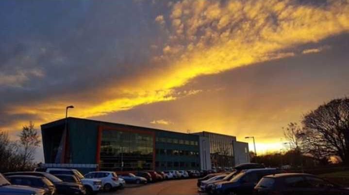 Image may contain: Architecture, Convention Center, Sedan, Sunlight, Parking, Parking Lot, Lighting, Sunrise, Outdoors, Nature, Sky, Office Building, Building, Car Dealership, Vehicle, Automobile, Car, Transportation