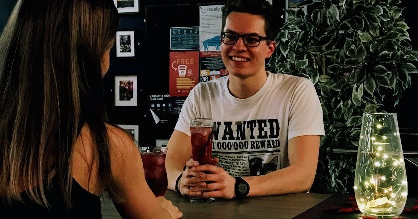 Image may contain: Man, T-Shirt, Glass, Alcohol, Smile, Drink, Beverage, Glasses, Accessories, Accessory, Face, Clothing, Apparel, Person, Human