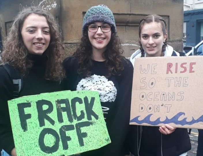 Image may contain: Banner, Protest, People, Female, Word, Crowd, Parade, Apparel, Clothing, Face, Text, Human, Person