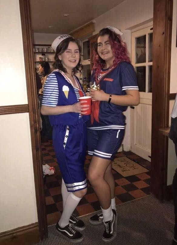 Image may contain: Symbol, Flag, Female, Door, Face, Costume, Human, Person, Clothing, Apparel, Shorts