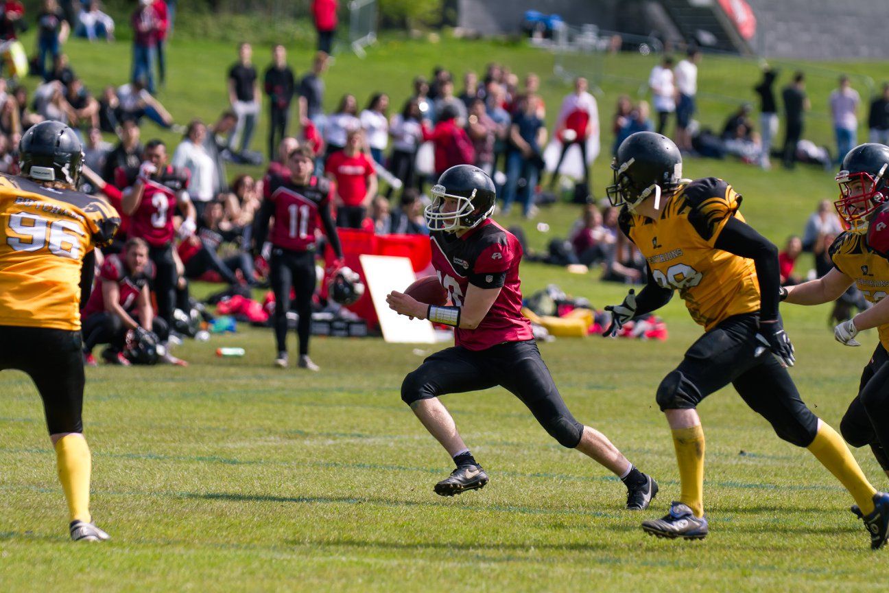 Image may contain: Football Helmet, Team Sport, American Football, Team, Football, Sports, Sport, People, Apparel, Clothing, Helmet, Human, Person