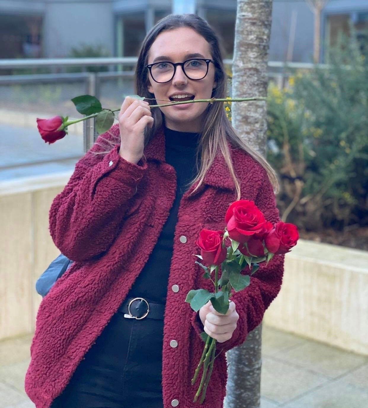 Image may contain: Long Sleeve, Coat, Cardigan, Flower, Blossom, Plant, Accessories, Accessory, Glasses, Sleeve, Sweater, Person, Human, Clothing, Apparel
