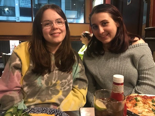 Image may contain: Portrait, Photography, Photo, Girl, Woman, Beverage, Drink, Seasoning, Plant, Dish, Clothing, Apparel, Female, Accessory, Glasses, Accessories, Face, Meal, Restaurant, Pizza, Food, Person, Human