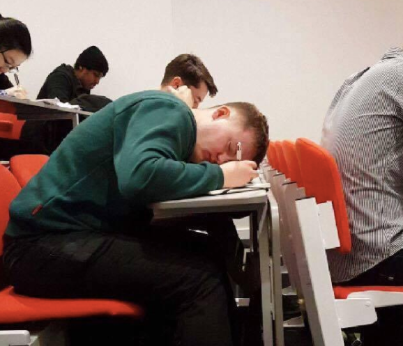 Image may contain: Classroom, Asleep, Furniture, Chair, Human, Person, People