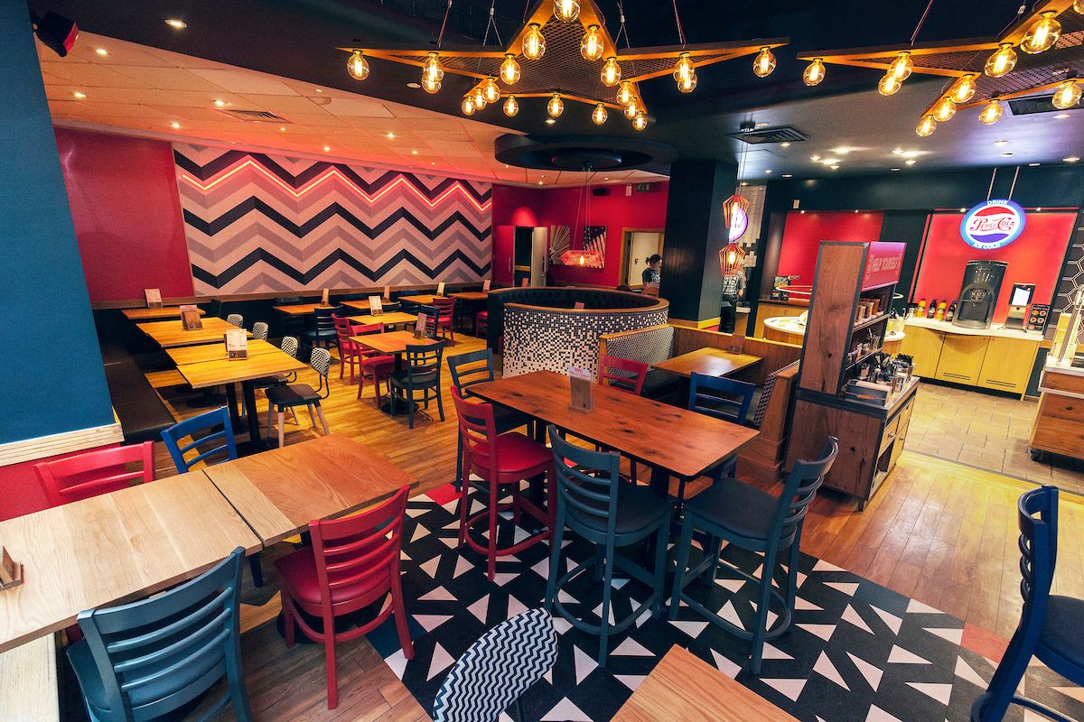 Image may contain: Trademark, Logo, Lighting, Restaurant, Cafe, Furniture, Chair