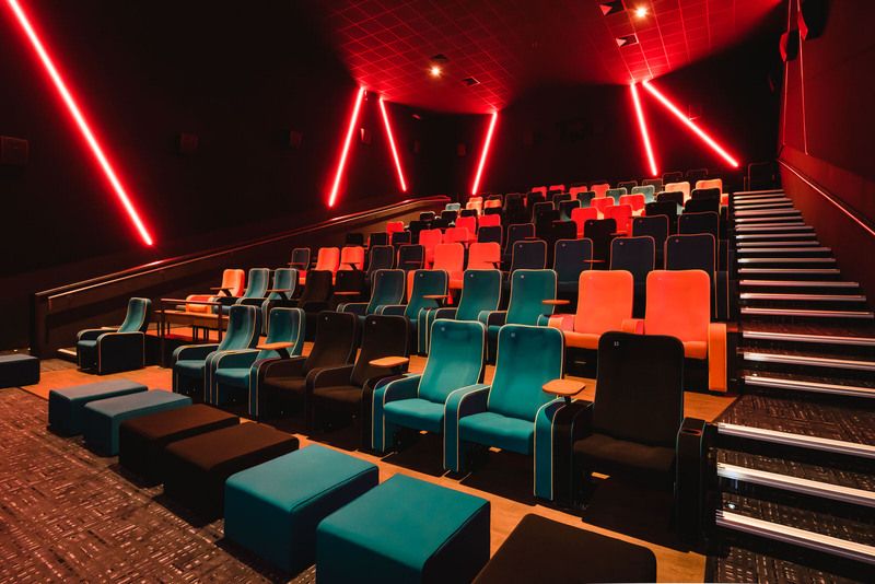 Image may contain: Upright Piano, Piano, Musical Instrument, Music, Leisure Activities, Theater, Room, Interior Design, Indoors, Hall, Auditorium, Couch, Home Theater, Entertainment Center, Electronics, Furniture, Chair, Suitcase, Luggage