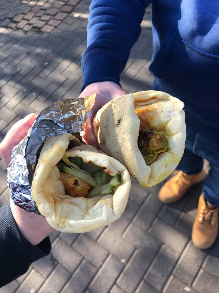 Image may contain: Hot Dog, Pita, Food, Bread, Human, Person, Apparel, Clothing, Footwear, Shoe