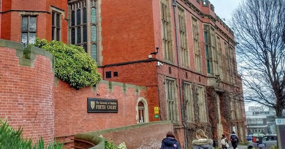 Image may contain: Architecture, City, Street, Road, Town, Human, Person, Neighborhood, Building, Urban, Brick