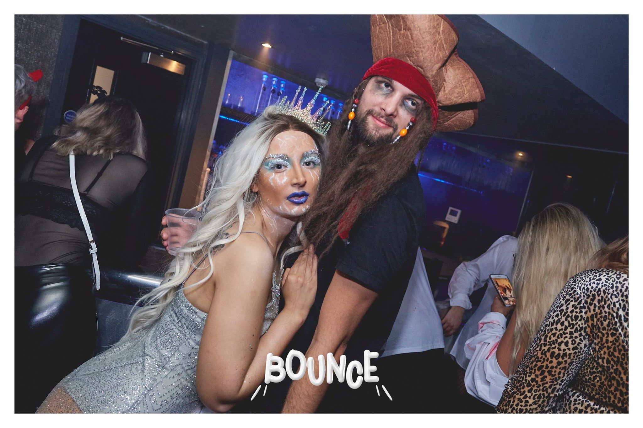 Image may contain: Apparel, Clothing, Bar Counter, Pub, Night Club, Face, Night Life, Club, Person, Human