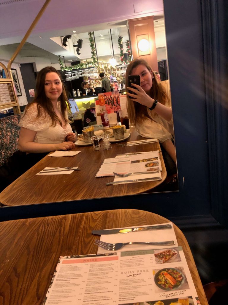 Image may contain: Cafeteria, Plywood, Cafe, Table, Furniture, Sitting, Wood, Food Court, Food, Restaurant, Person, Human