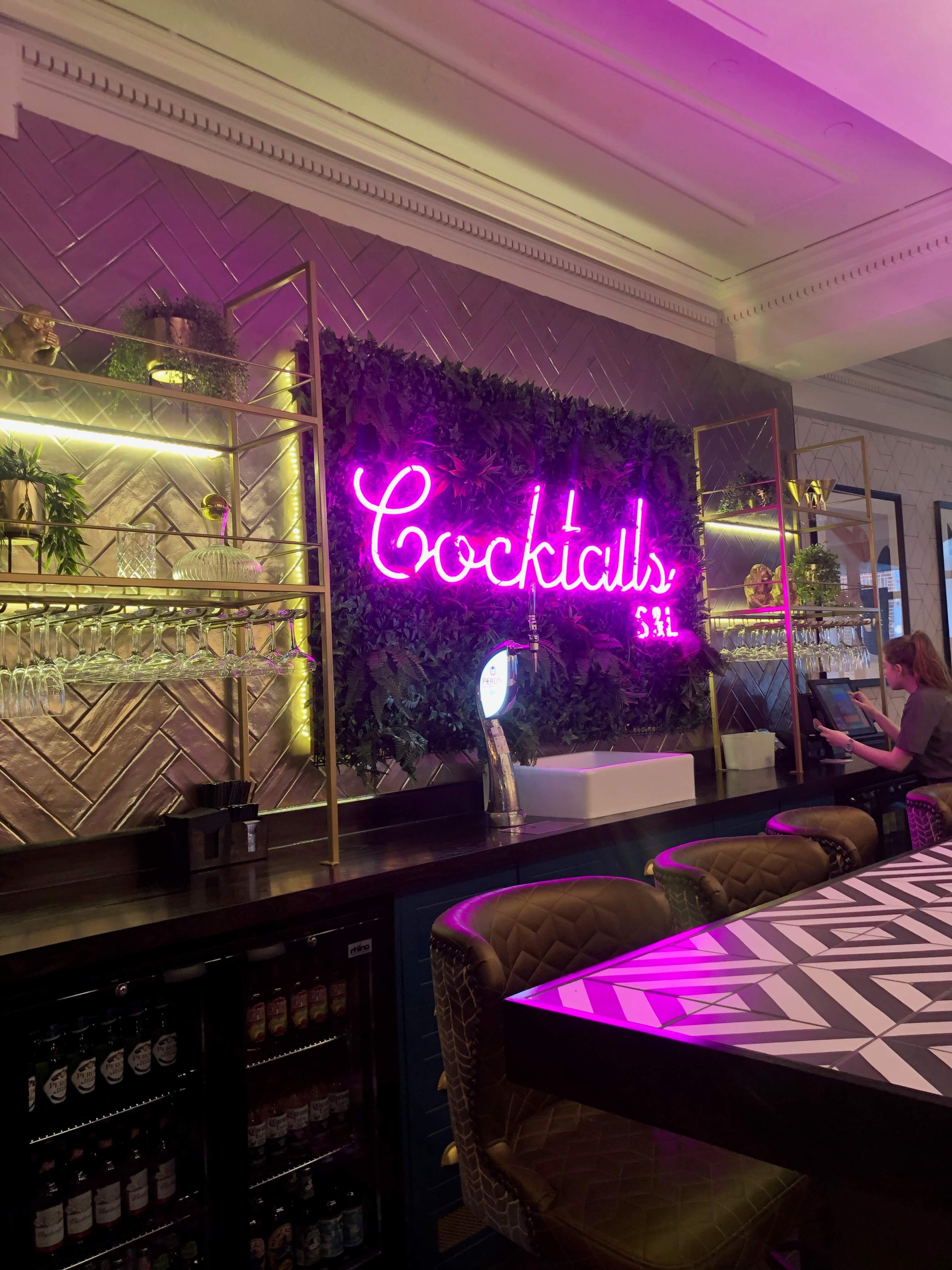 Image may contain: Interior Design, Lighting, Indoors, Living Room, Room, Bar Counter, Restaurant, Pub, Human, Person