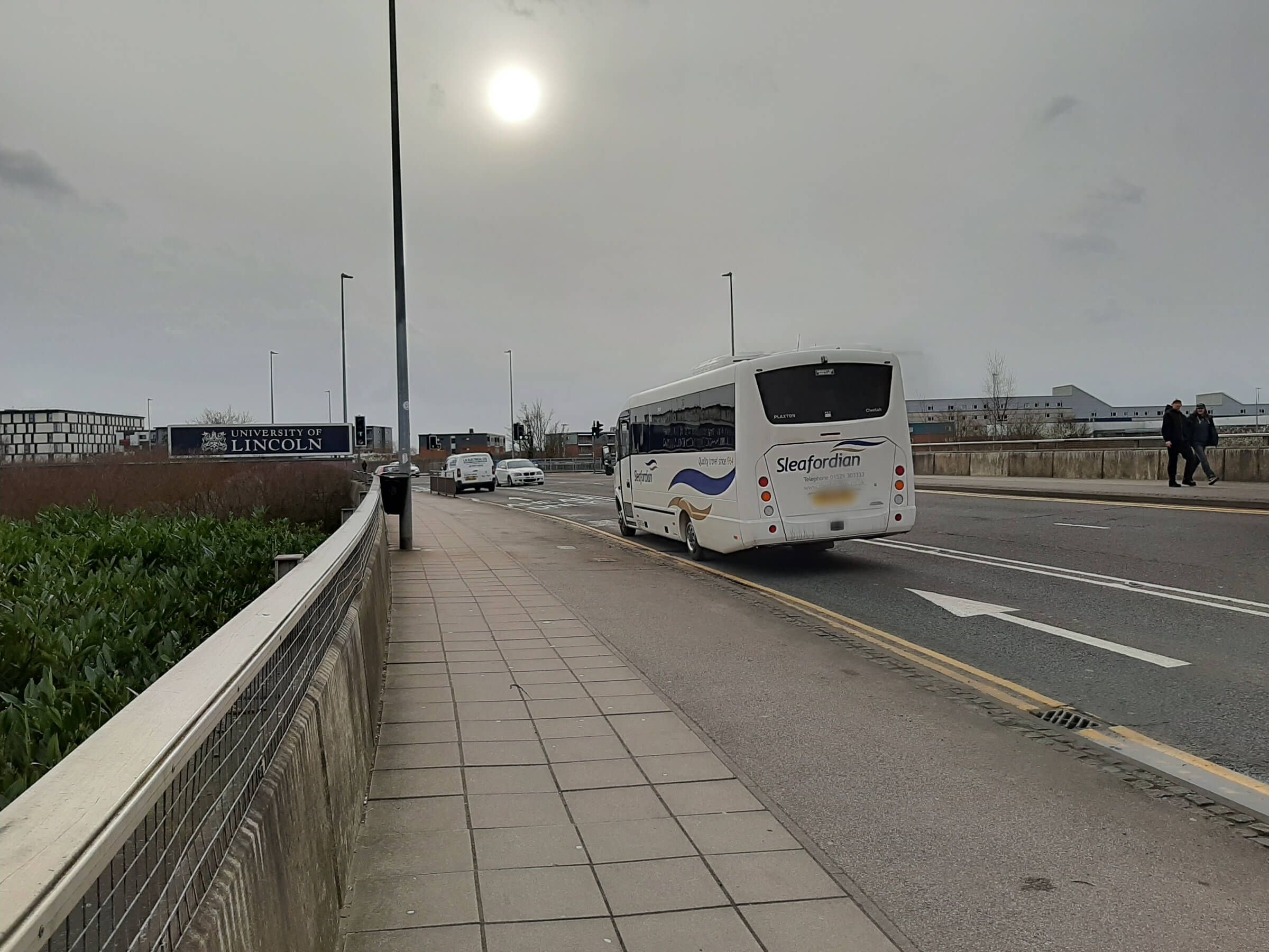 Image may contain: Freeway, Path, Road, Tarmac, Asphalt, Bus, Vehicle, Transportation, Person, Human
