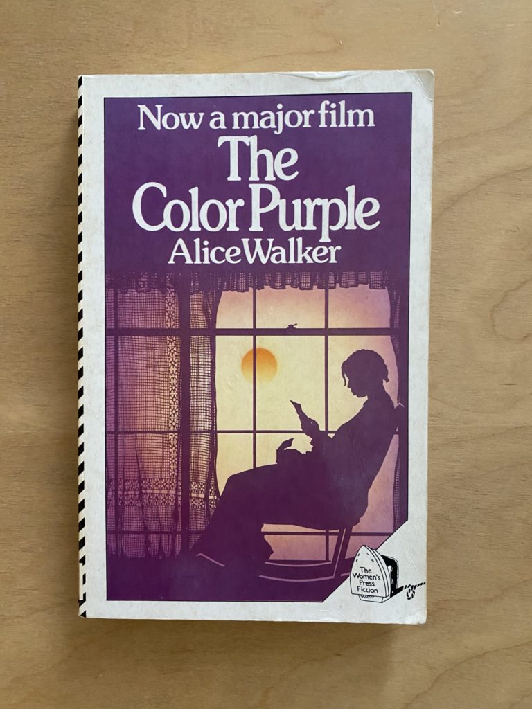 A purple book cover with a silhouette of a woman sat by a window reading a letter.