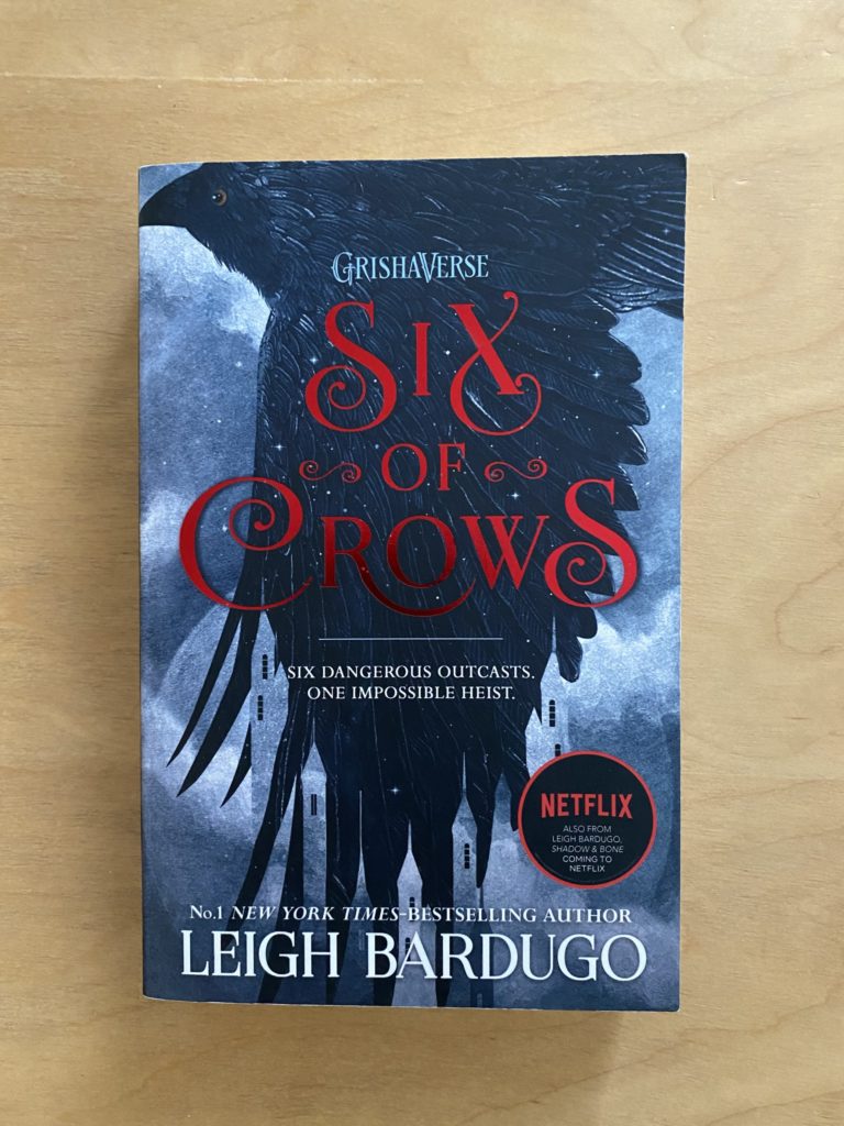 A book with a crow on the cover and the title in red.