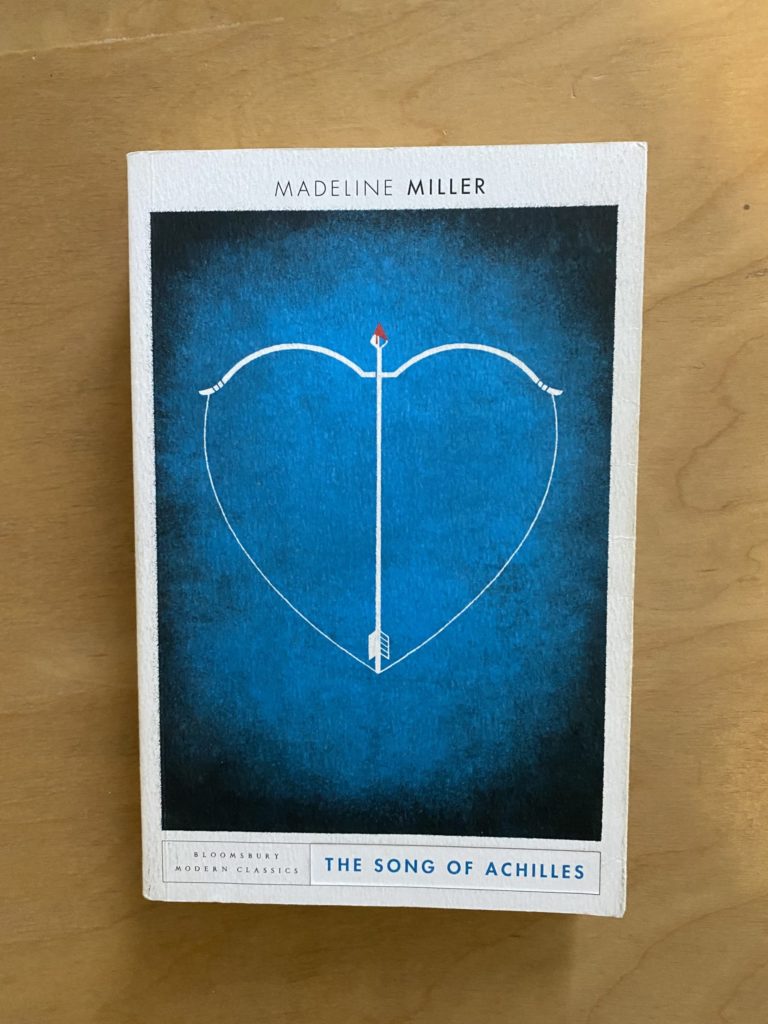 A white and blue book with a bow and arrow shaped like a heat on the front.