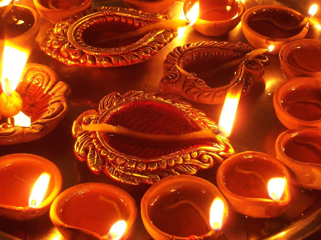 Image may contain: Candle, Drink, Beverage, Flame, Fire, Diwali