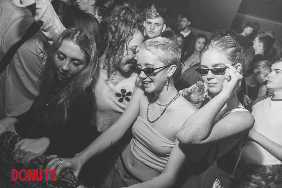 Image may contain: Crowd, Female, Apparel, Clothing, Glasses, Club, Necklace, Jewelry, Face, Party, Accessories, Sunglasses, Accessory, Person, Human