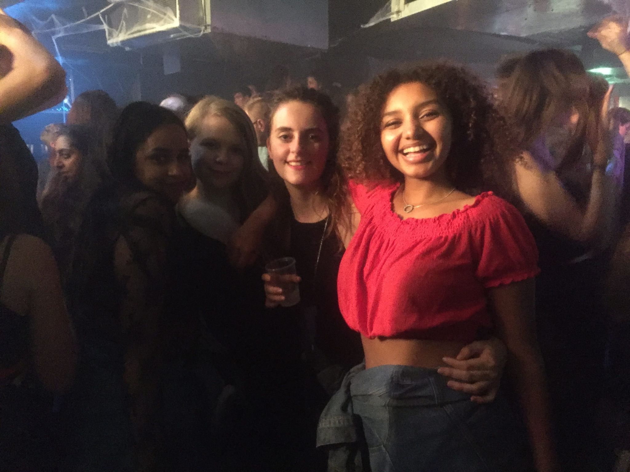 Image may contain: Night Club, Club, Bar Counter, Pub, Afro Hairstyle, Hair, Night Life, Human, Person