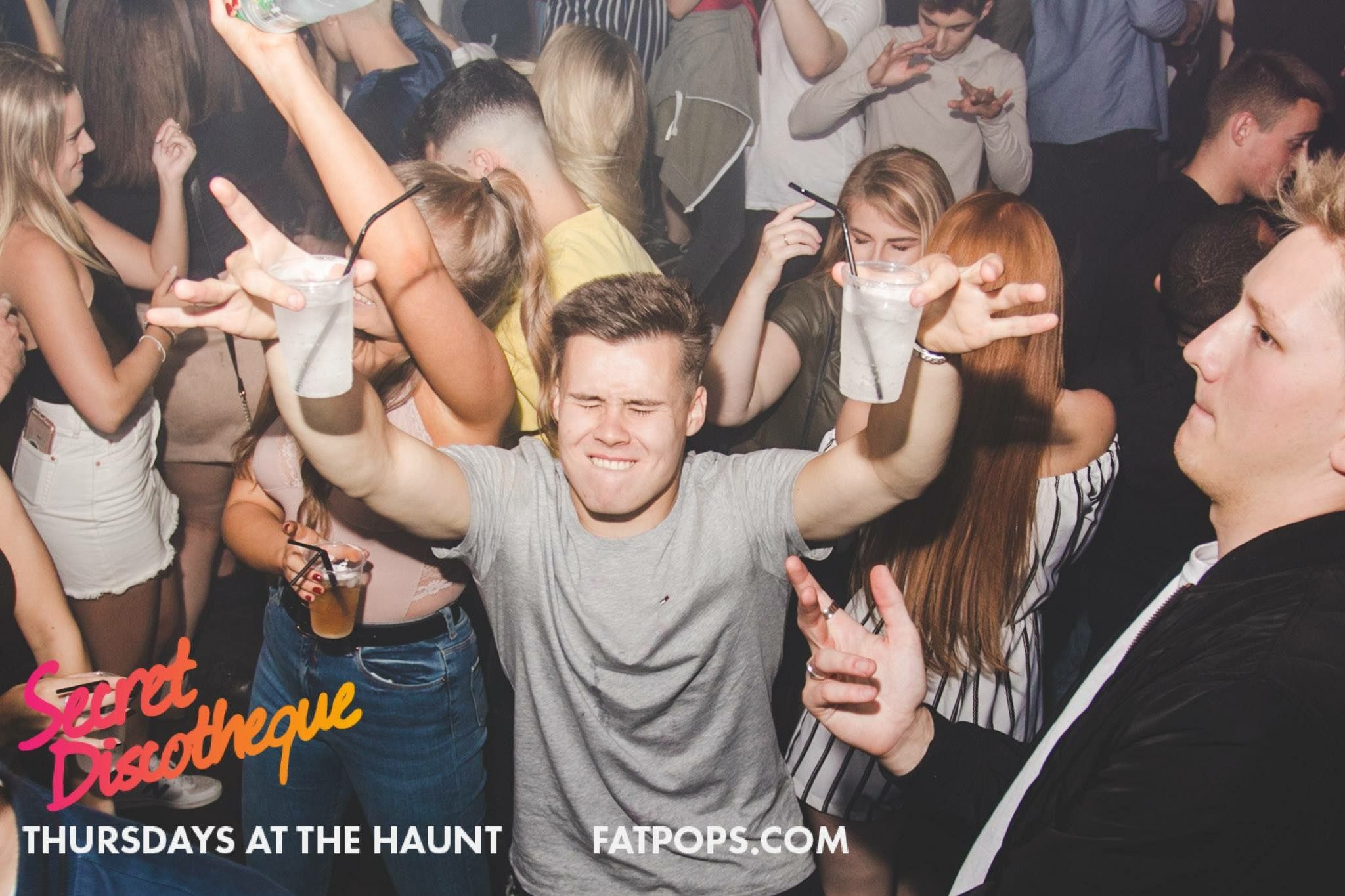 Image may contain: Suit, Overcoat, Coat, Apparel, Clothing, Night Life, Night Club, Club, Party, Person, Human