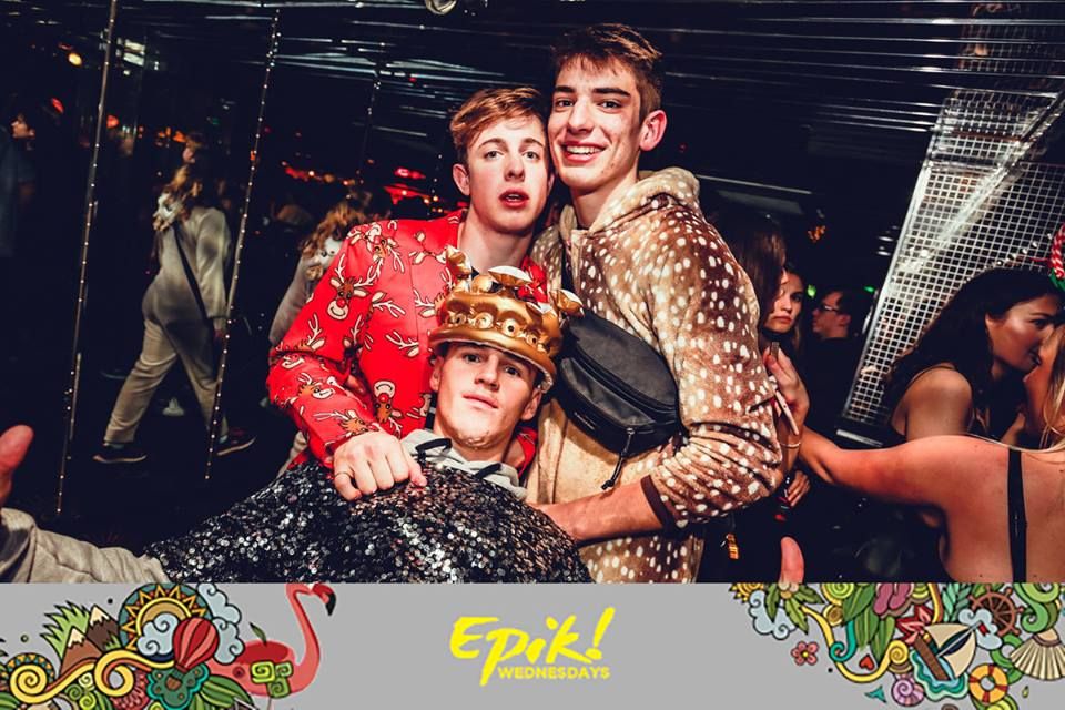 Image may contain: People, Party, Clothing, Apparel, Helmet, Face, Night Club, Club, Human, Person