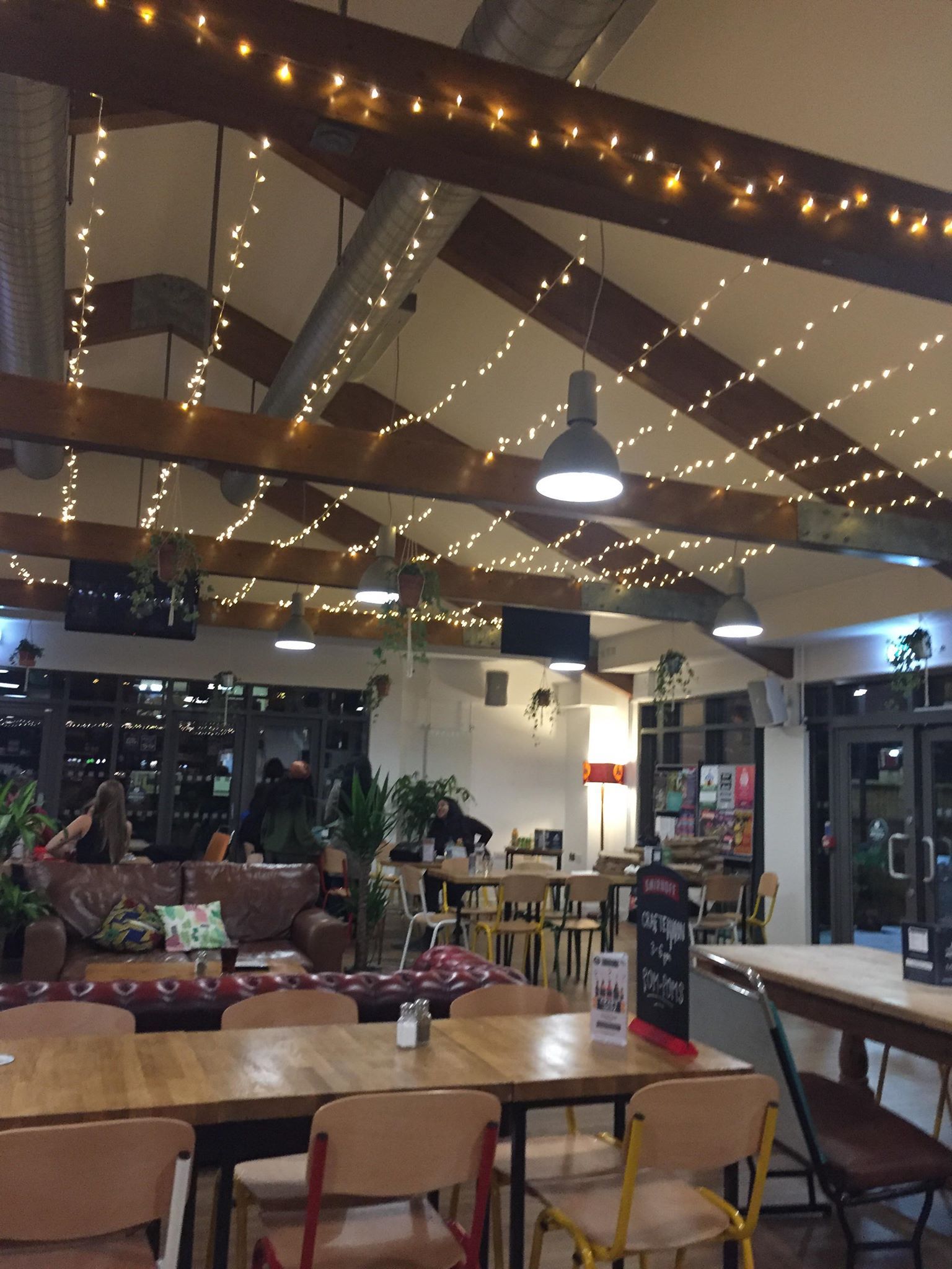 Image may contain: Table, Plywood, Pub, Food, Food Court, Human, Person, Cafeteria, Cafe, Wood, Restaurant, Chair, Furniture