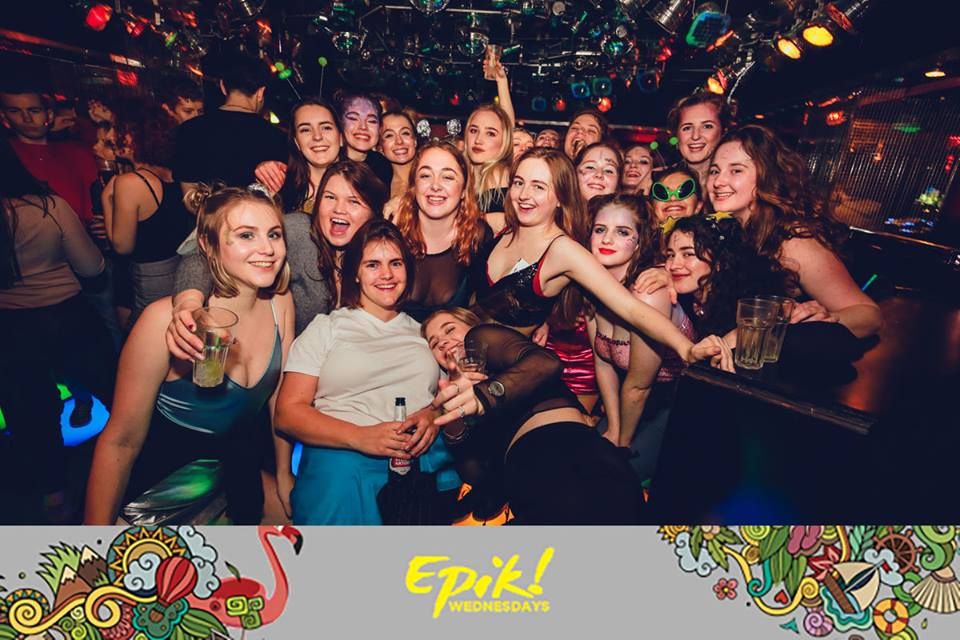 Image may contain: People, Alcohol, Drink, Beer, Beverage, Smile, Night Club, Club, Night Life, Face, Human, Person, Party