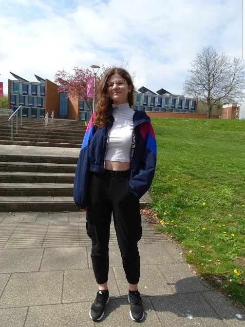 Image may contain: Face, Housing, Building, Urban, Neighborhood, Yard, Girl, Shoe, Footwear, Jeans, Denim, Woman, Path, Nature, Tree, Grass, Outdoors, Blazer, Coat, Jacket, Bush, Female, Vegetation, Plant, Human, Person, Pants, Clothing, Apparel