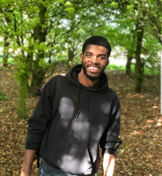Image may contain: Pants, Path, Face, Long Sleeve, Grove, Sleeve, Human, Person, Sweatshirt, Sweater, Forest, Woodland, Tree, Nature, Outdoors, Land, Plant, Vegetation, Clothing, Apparel