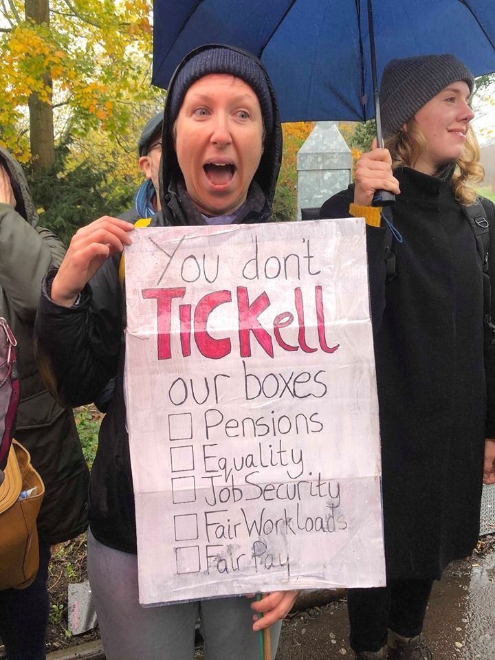 Image may contain: Tree, Plant, Parade, Coat, Face, Crowd, Banner, Clothing, Apparel, Text, Human, Person