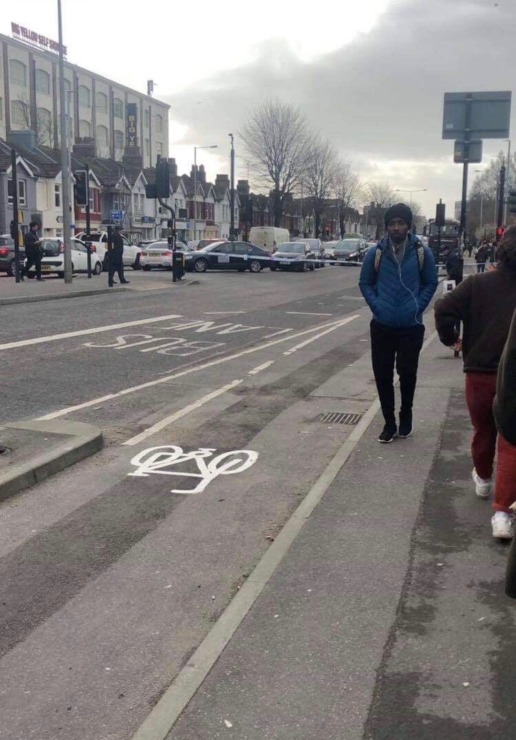 Image may contain: Intersection, Zebra Crossing, Path, Transportation, Vehicle, Car, Automobile, Road, Tarmac, Asphalt, Apparel, Shoe, Footwear, Clothing, Pedestrian, Person, Human