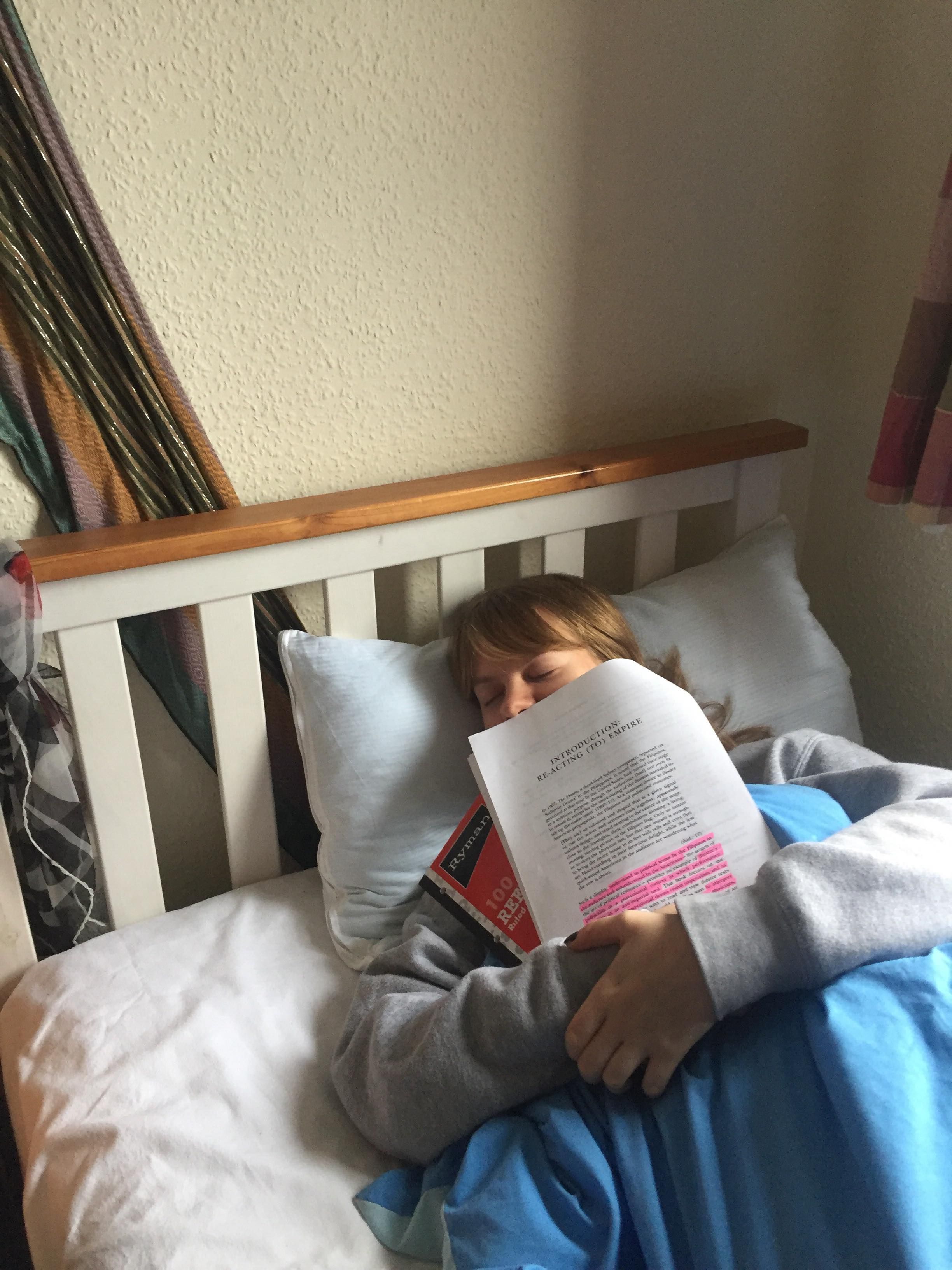 Image may contain: Furniture, Bed, Book, Reading