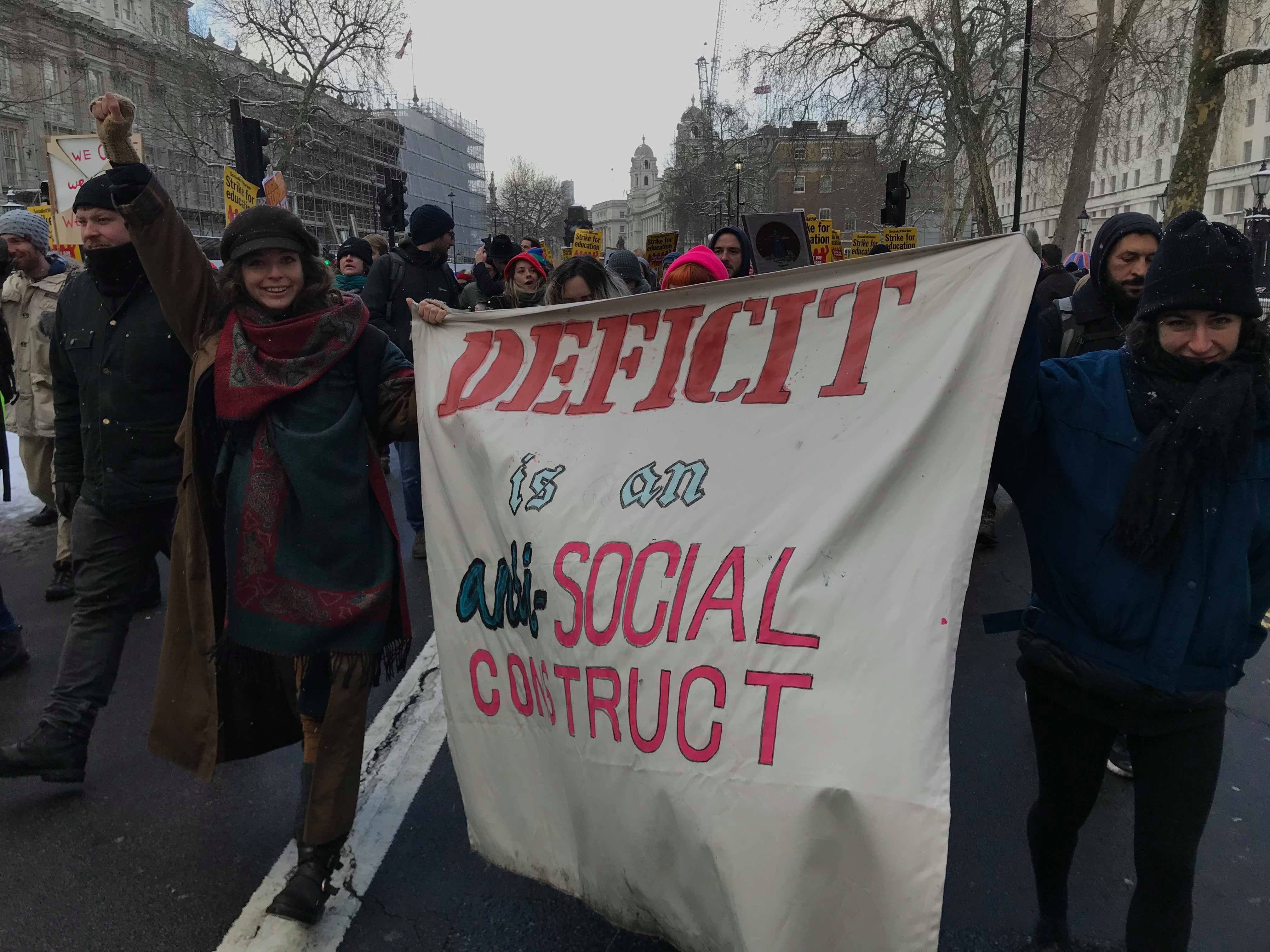 Image may contain: Parade, Crowd, Text, Banner, Person, People, Human