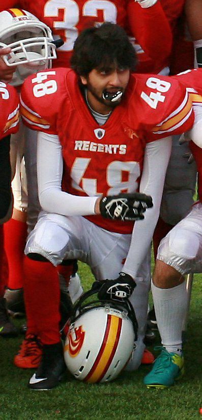Image may contain: Sphere, Ball, Team Sport, Team, Sports, Sport, Helmet, Hardhat, Football Helmet, Football, Crash Helmet, Clothing, American Football, Person, People, Human