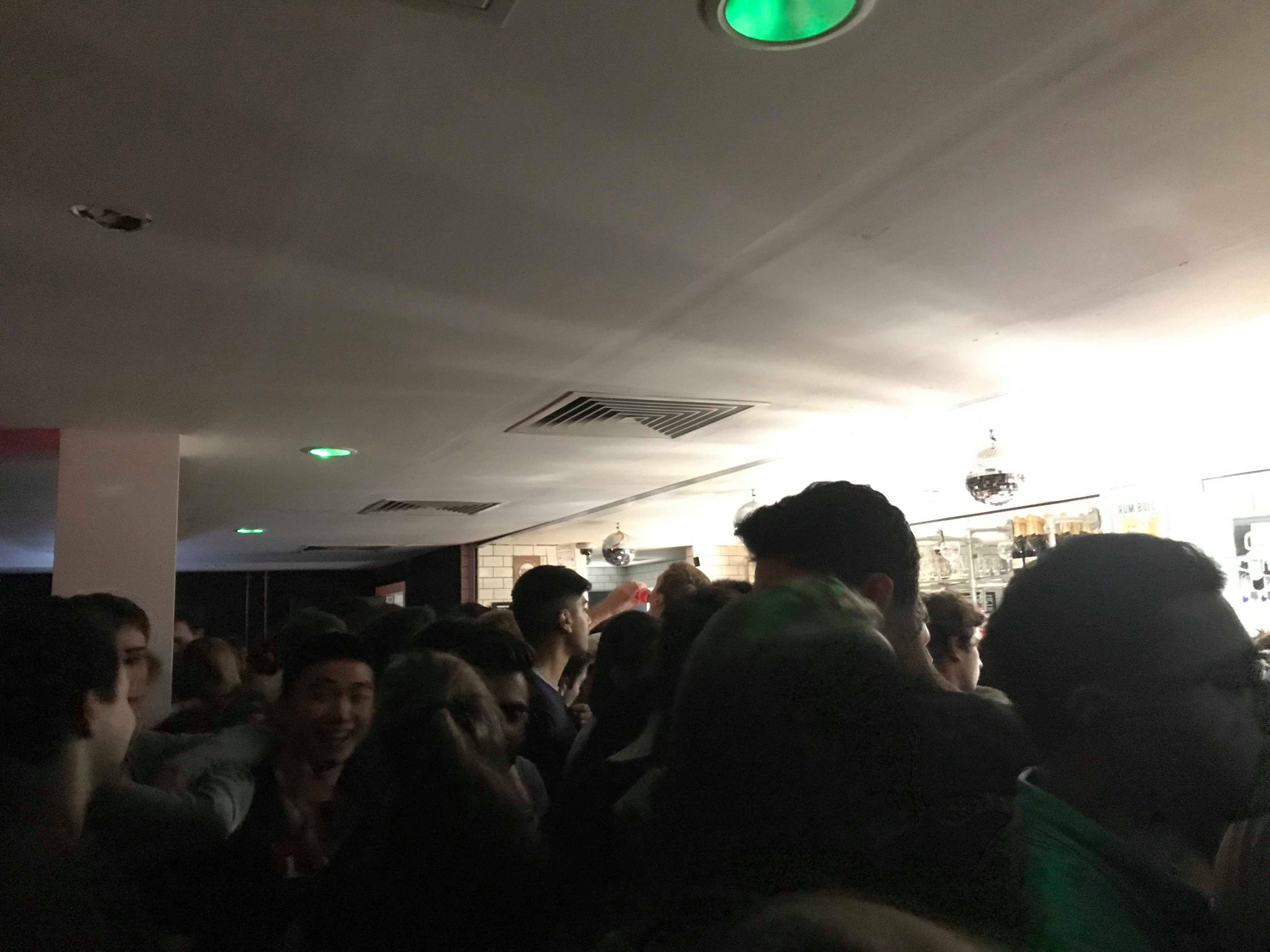 Image may contain: Lighting, Pub, Night Life, Audience, Crowd, Interior Design, Indoors, Human, Person