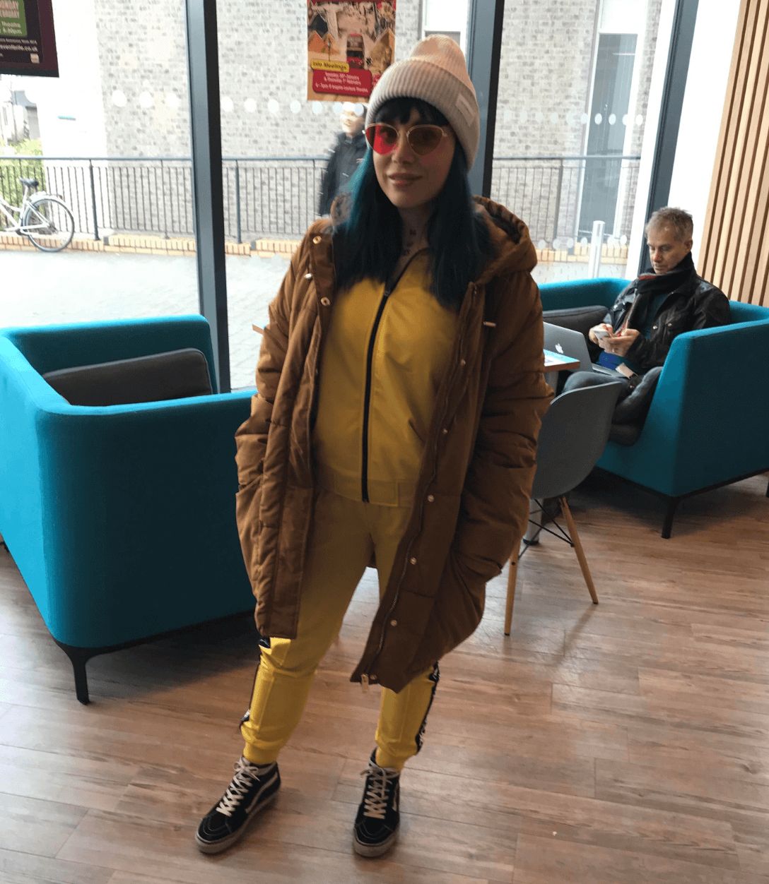 Image may contain: Sitting, Coat, Floor, Plywood, Chair, Couch, Furniture, Flooring, Accessory, Accessories, Sunglasses, Human, Person, Shoe, Footwear, Hardwood, Wood, Clothing, Apparel