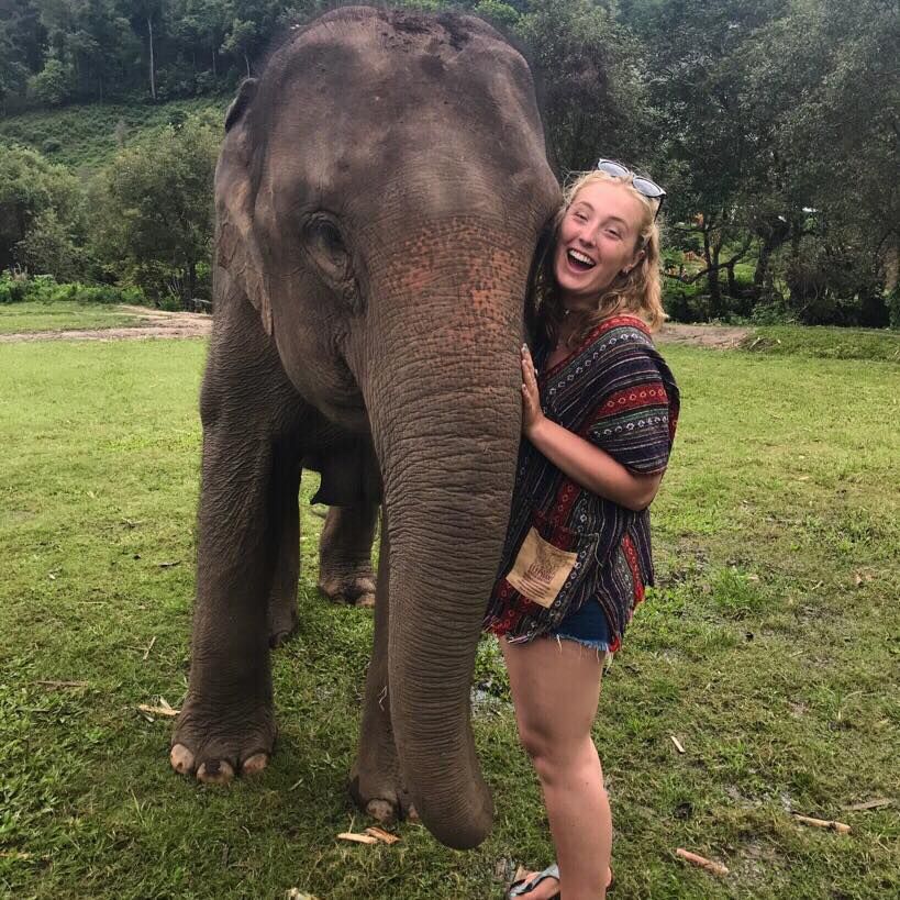 Image may contain: Zoo, Vacation, Face, Female, Apparel, Clothing, Outdoors, Lawn, Park, Tree, Grass, Vegetation, Plant, Person, Human, Wildlife, Elephant, Mammal, Animal