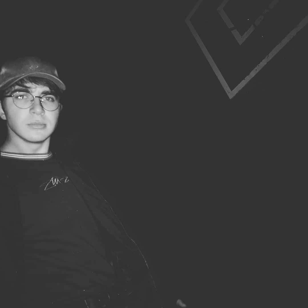 Image may contain: Baseball Cap, Photography, Photo, Portrait, Cap, Hat, Face, Accessory, Glasses, Accessories, Human, Person, Long Sleeve, Sleeve, Clothing, Apparel