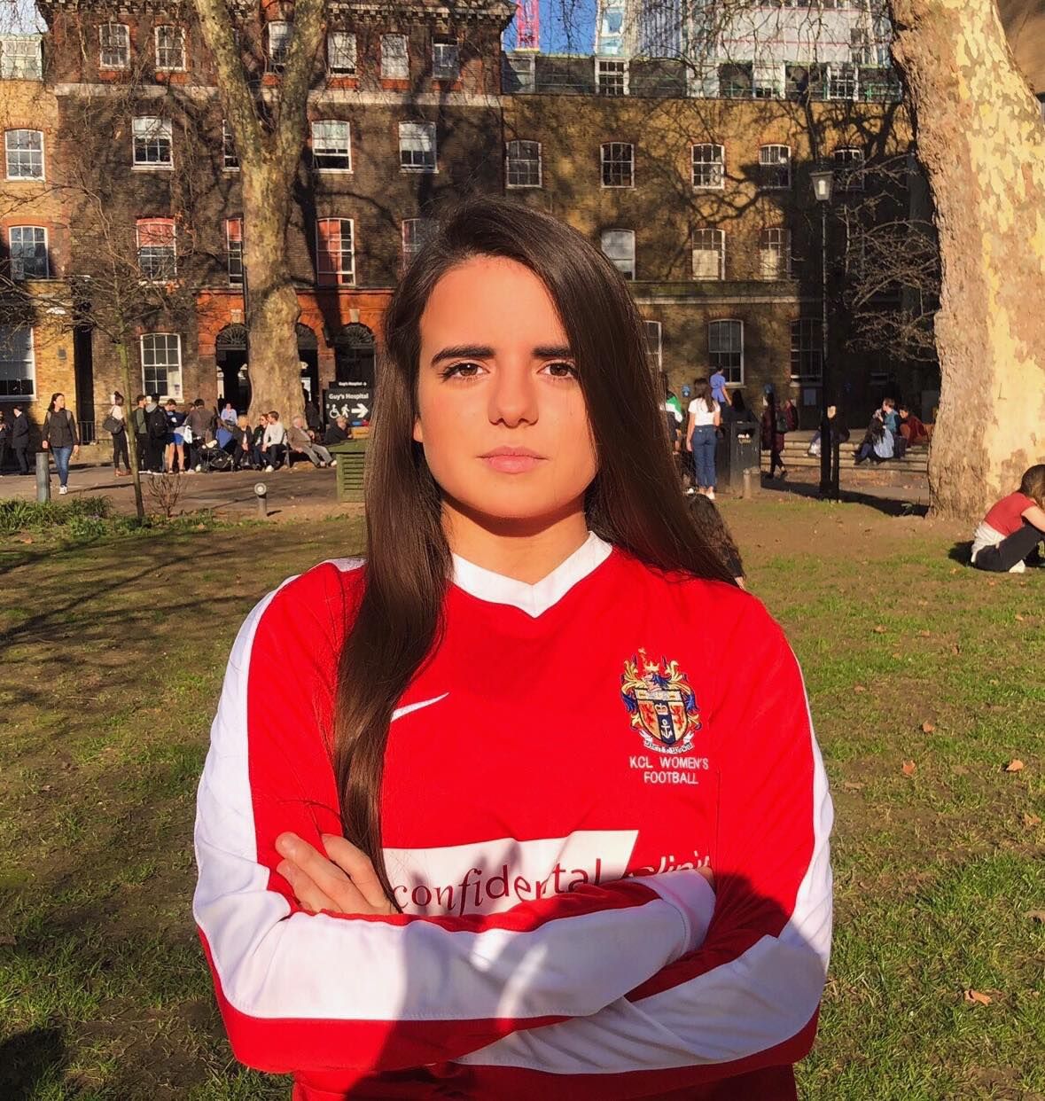 Image may contain: Shorts, Campus, Downtown, City, Urban, Town, Sleeve, Female, Architecture, Building, Tree, Plant, Grass, Clothing, Apparel, Person, Human
