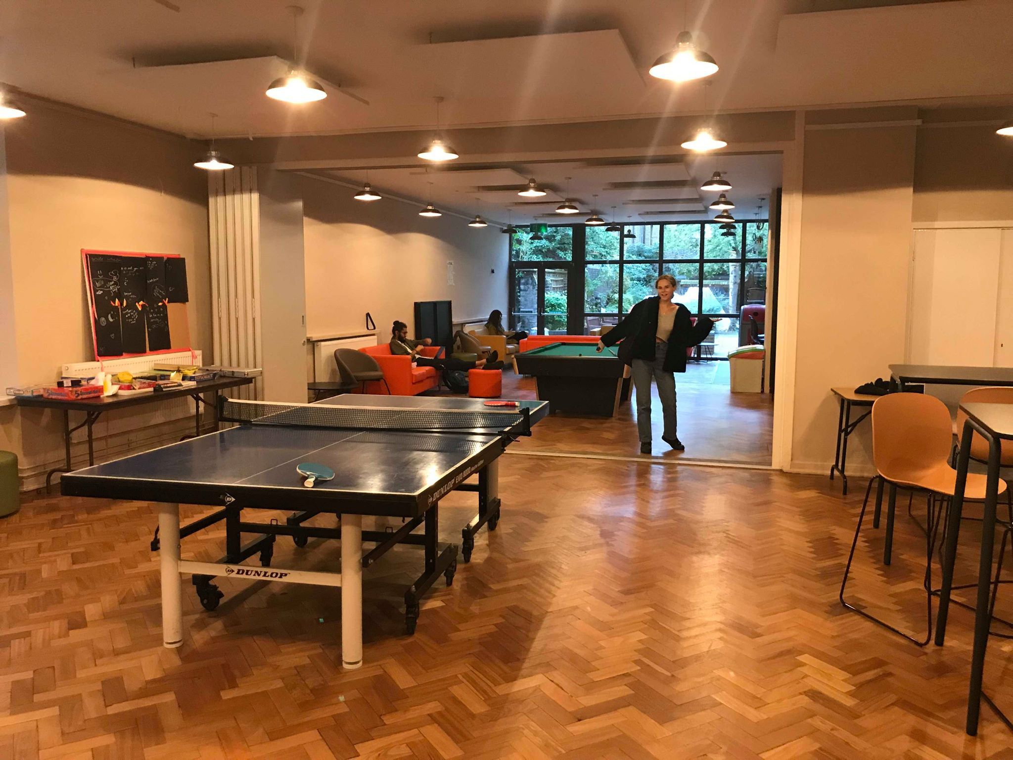Image may contain: Interior Design, Billiard Room, Chair, Table, Furniture, Room, Hardwood, Indoors, Wood, Floor, Human, Person, Flooring