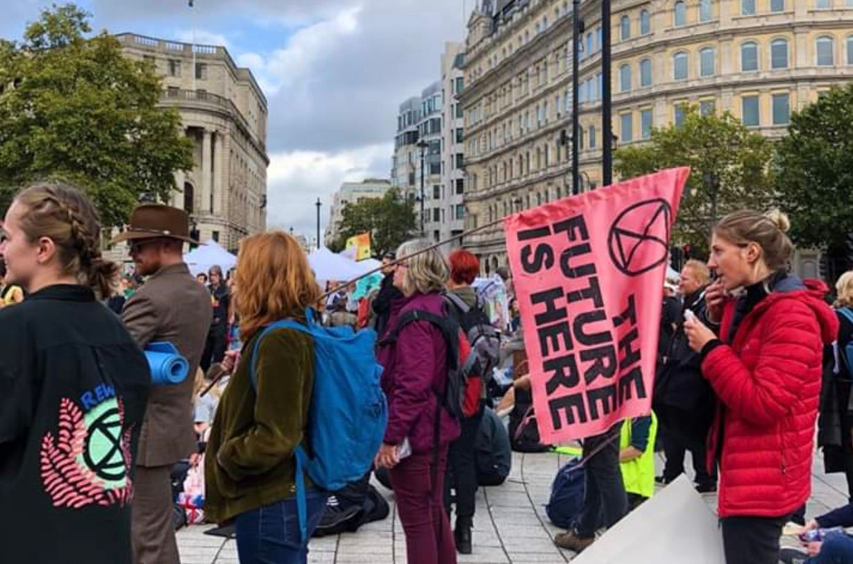 Image may contain: Text, Pedestrian, Parade, Crowd, Human, Person