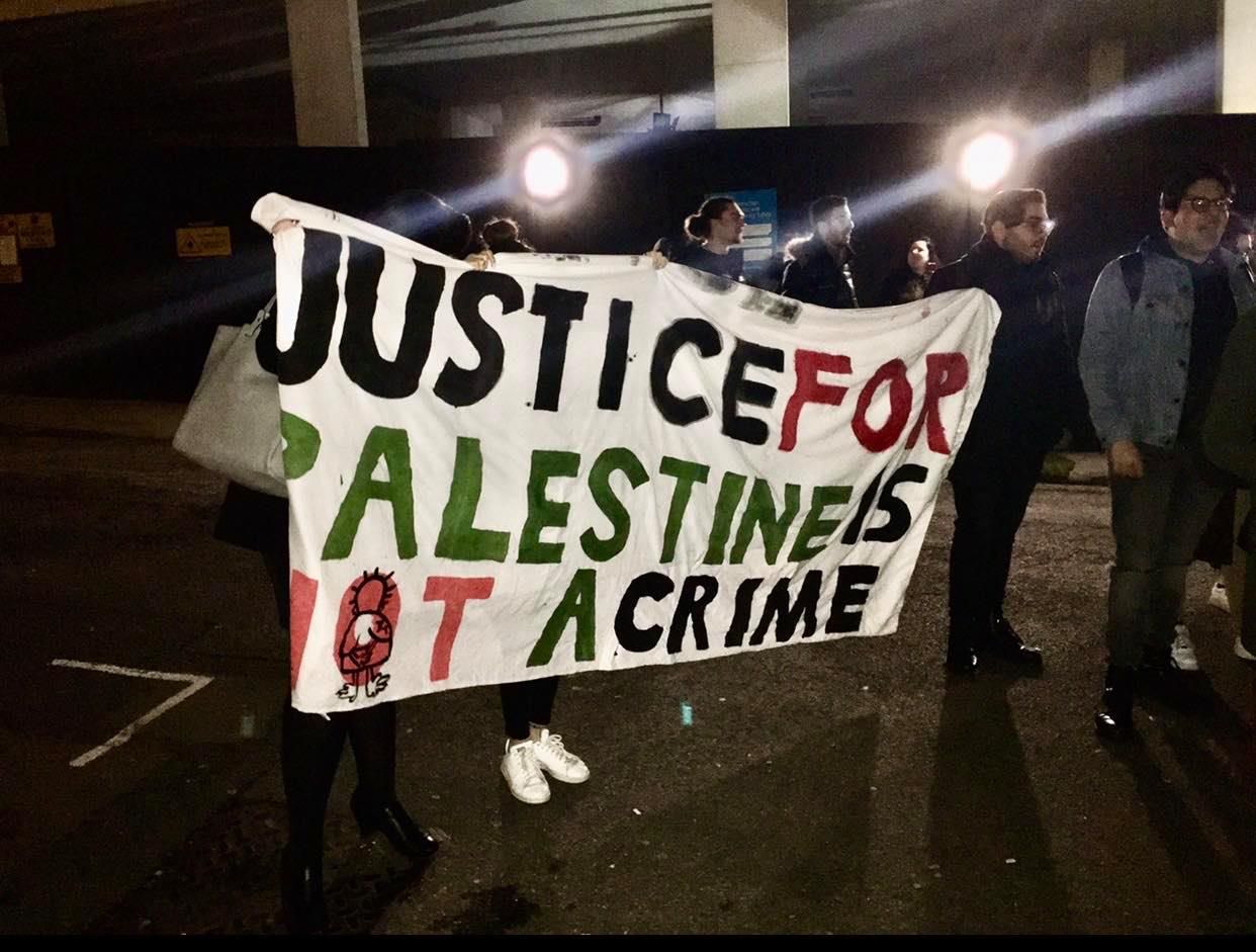 Image may contain: Crowd, Human, Person, Banner, Text