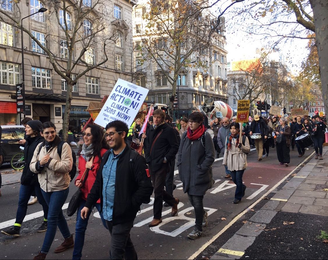 Image may contain: Zebra Crossing, Crowd, Text, Road, Tarmac, Asphalt, Pedestrian, Footwear, Clothing, Shoe, Apparel, Person, Human