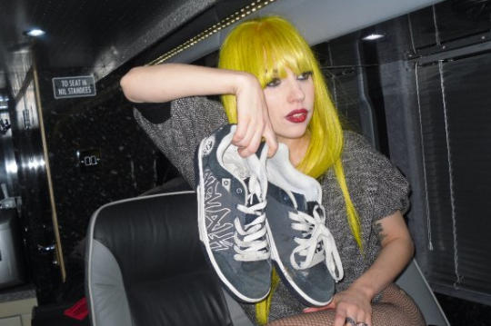Pictured: Lady Gaga holding Jordan's shoes on her tour bus