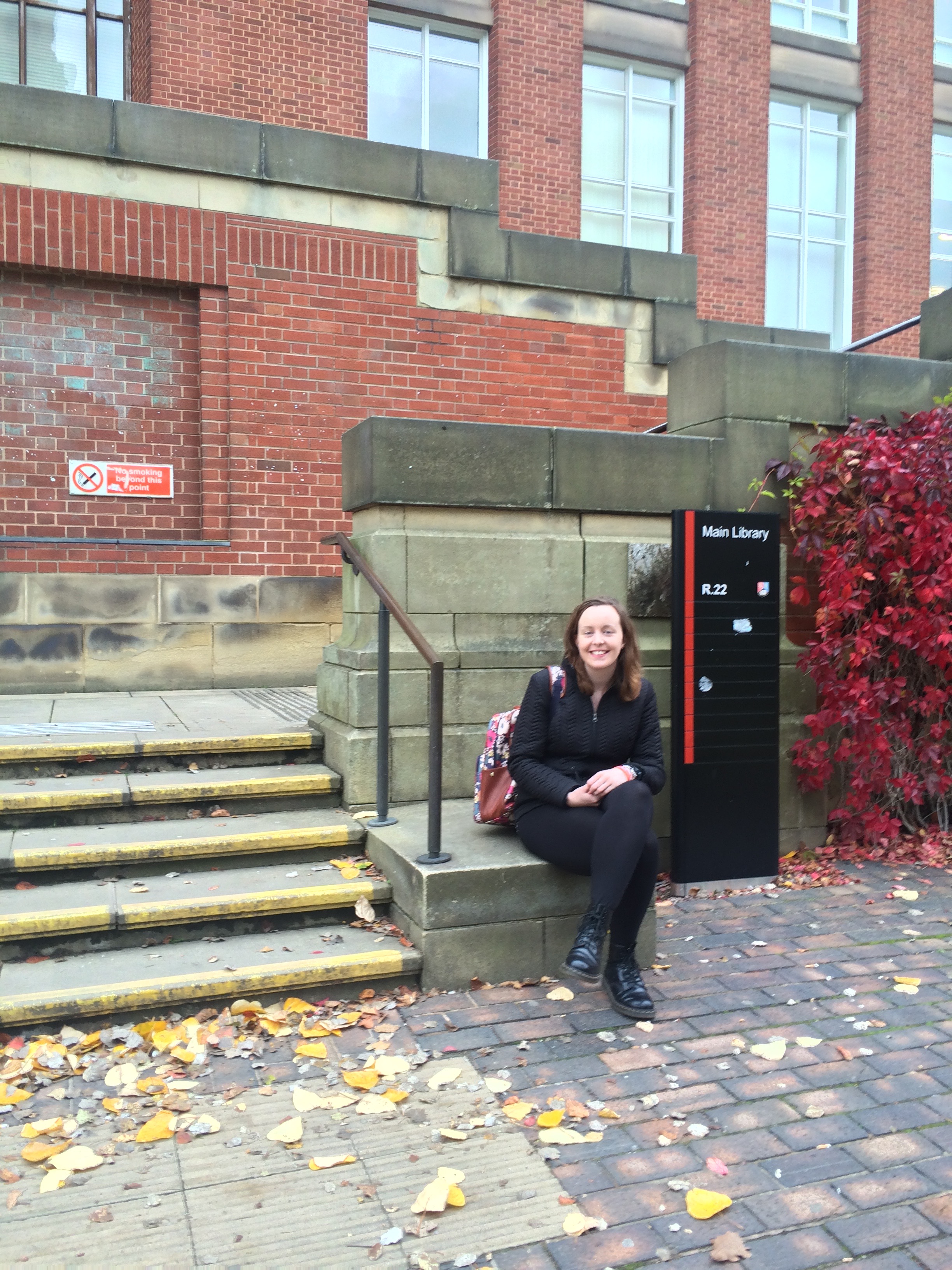Sitting by the soon-to-be-demolished library. 