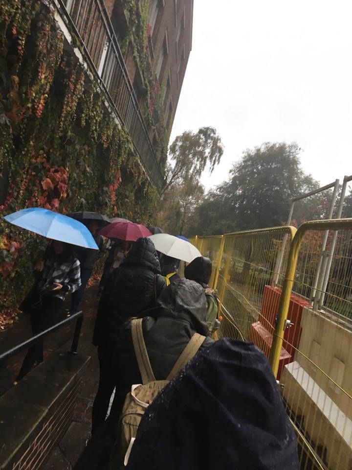 Image may contain: Vehicle, Train, Human, Person, People, Umbrella