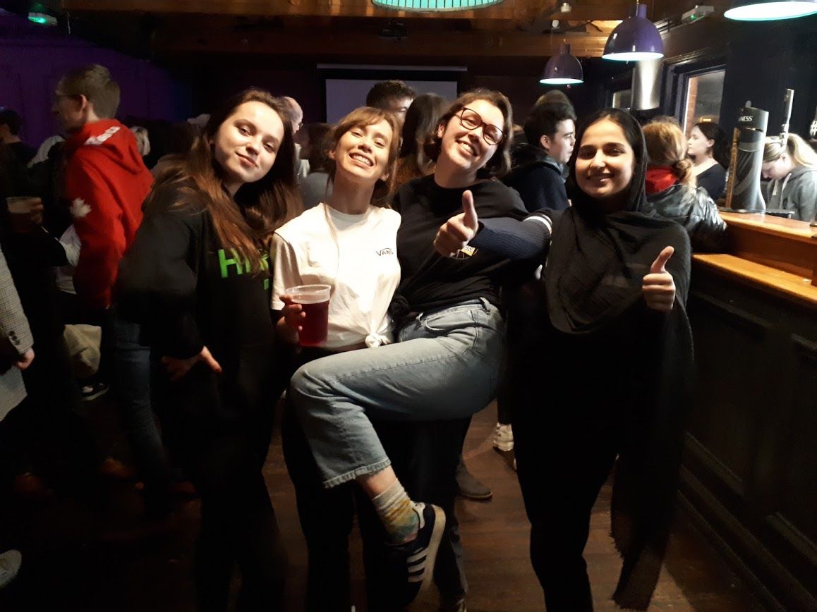 Image may contain: People, Beverage, Drink, Face, Night Club, Audience, Crowd, Club, Shoe, Footwear, Lighting, Party, Bar Counter, Pub, Clothing, Apparel, Indoors, Interior Design, Night Life, Human, Person